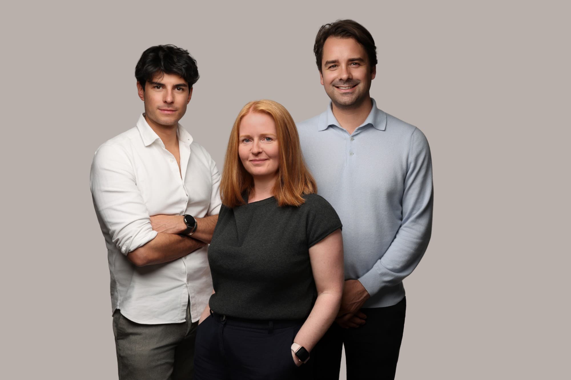 Patricio Fernandez Weisson, Emma Ogburn and Jorn Jansen Schoonhoven standing together against a grey backdrop